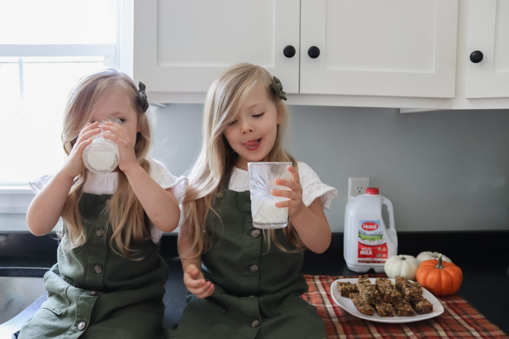 Toddlers drinking Hood whole milk with pumpkin chocolate chip granola bars